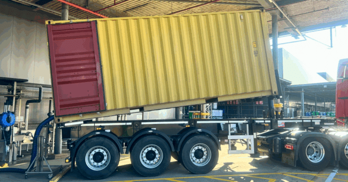 Container being downloaded in tipping chassis